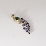 Royal Peacock Brooch Elegant peacock brooch adorned with vivid blue sapphires, rich emerald, and brilliant diamonds, beautifully capturing regal grace and timeless sophistication.(PGDBRCH002)