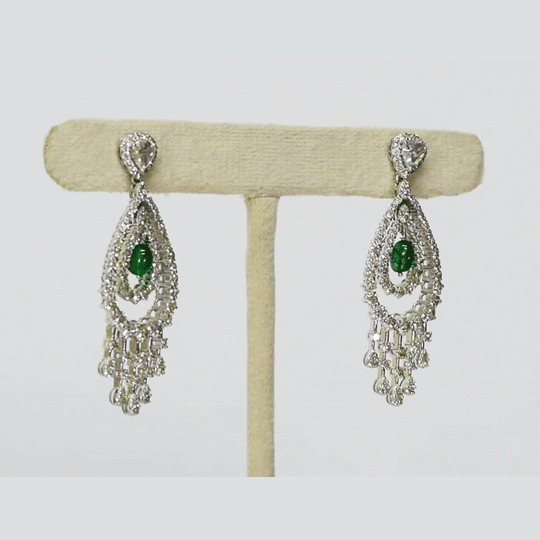 Beautifully crafted long earrings featuring round diamonds, polki diamonds, and emerald mani beads, offering classic style and graceful charm. (PGDE0422)