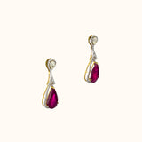 Graceful ruby pear earrings accented with brilliant diamonds, offering a classic yet luxurious style that never goes unnoticed.(PGDE0440)