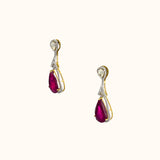 Graceful ruby pear earrings accented with brilliant diamonds, offering a classic yet luxurious style that never goes unnoticed.(PGDE0440)