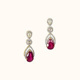 Graceful ruby pear paired with sparkling diamonds create elegant earrings that radiate beauty, brilliance, and timeless sophistication.(PGDE0442)