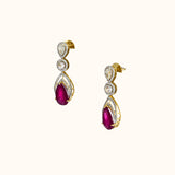 Graceful ruby pear paired with sparkling diamonds create elegant earrings that radiate beauty, brilliance, and timeless sophistication.(PGDE0442)