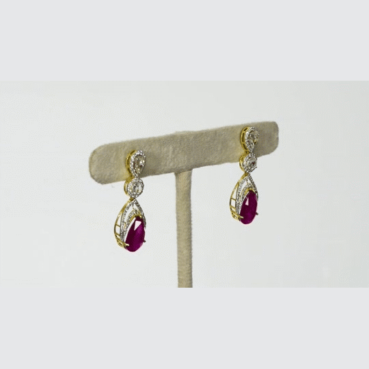 Graceful ruby pear paired with sparkling diamonds create elegant earrings that radiate beauty, brilliance, and timeless sophistication.(PGDE0442)