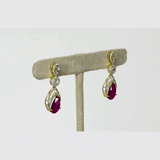 Graceful ruby pear paired with sparkling diamonds create elegant earrings that radiate beauty, brilliance, and timeless sophistication.(PGDE0442)
