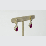 Graceful ruby pear paired with sparkling diamonds create elegant earrings that radiate beauty, brilliance, and timeless sophistication.(PGDE0442)