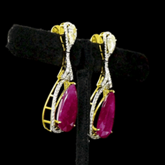 Ruby & Diamond Drop Earrings Graceful drop earrings showcasing vibrant pear-shaped rubies, accented with brilliant round diamonds and elegant pear-cut diamonds for timeless sophistication and brilliance.(PGDE0451)