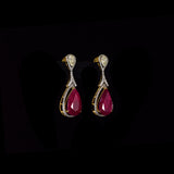 Ruby & Diamond Drop Earrings Graceful drop earrings showcasing vibrant pear-shaped rubies, accented with brilliant round diamonds and elegant pear-cut diamonds for timeless sophistication and brilliance.(PGDE0451)
