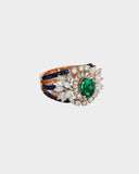 An elegant ring featuring emerald, sapphire, and diamonds, blending rich colour and brilliance for a sophisticated statement design. (PGDR0458)