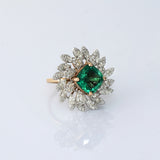 A fine emerald centerpiece surrounded by sparkling diamonds, creating a graceful ring that radiates timeless elegance and brilliance.(PGDR0460)