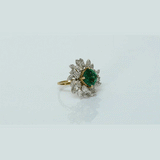 A fine emerald centerpiece surrounded by sparkling diamonds, creating a graceful ring that radiates timeless elegance and brilliance.(PGDR0460)