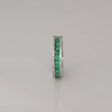 A timeless eternity band showcasing vivid channel-set emeralds, framed by brilliant round diamonds for an elegant statement of everlasting luxury.(PGDR0510)