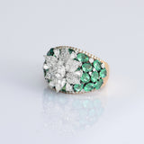Featuring a sparkling diamond flower centerpiece surrounded by rich green emeralds, this ring is a true symbol of refined elegance. (PGDR0516)
