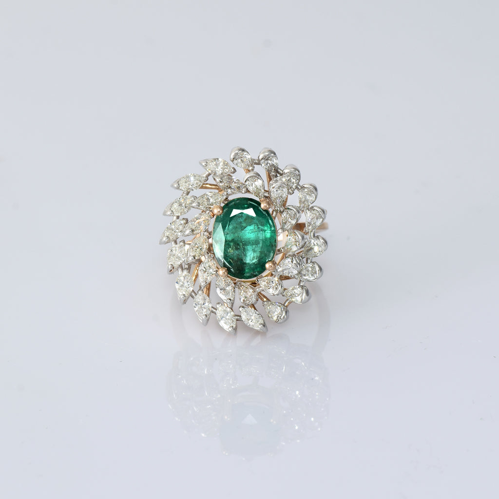 A vibrant emerald centerpiece surrounded by sparkling diamonds, creating a graceful ring filled with timeless elegance and charm.(PGDR0520)