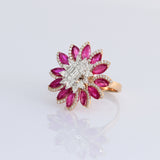 Ruby petals and sparkling diamonds bloom together in this floral ring, creating a vibrant and elegant statement piece.(PGDR0521)