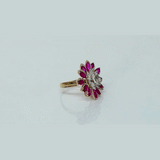 Ruby petals and sparkling diamonds bloom together in this floral ring, creating a vibrant and elegant statement piece.(PGDR0521)