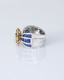 Featuring a diamond cluster center, encircled by vivid emeralds and accented with channel-set sapphires, this ring is designed to make a powerful statement. (PGDR0523)