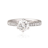 A timeless solitaire diamond ring with a brilliant round center stone and diamond-studded band, crafted for everlasting elegance.(PGDR0533)