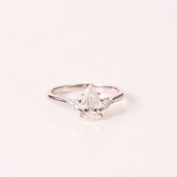 A breathtaking pear-shaped diamond embraced by shimmering side stones, creating a ring of effortless elegance.(PGDR0536)