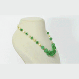 Exquisite carved Colombian emeralds paired with lustrous South Sea pearls, meticulously strung in gold wire to create refined timeless beauty.(STRG290)