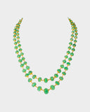 A luxurious double-line string of intricately carved emerald beads, delicately strung on gold wire, radiating timeless elegance and sophistication. (STRG348)