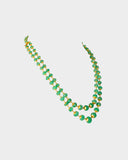 A luxurious double-line string of intricately carved emerald beads, delicately strung on gold wire, radiating timeless elegance and sophistication. (STRG348)