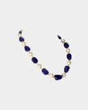 A single-line necklace with South Sea pearls and long tanzanite maniya, strung on gold wire for a simple, elegant, and timeless look.(STRG360)