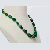 A single-line string of vibrant emerald maniya delicately strung on gold wire, showcasing timeless elegance.(STRG364)