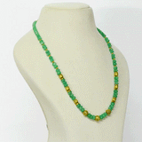 A refined string of intricately carved emerald beads accented with ornate gold beads, blending heritage artistry with enduring elegance and sophistication.(STRG378)