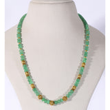 A refined string of intricately carved emerald beads accented with ornate gold beads, blending heritage artistry with enduring elegance and sophistication.(STRG378)