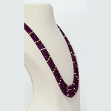 A luxurious three-layer necklace of premium Burmese ruby beads accented with diamond rondelles, showcasing rich colour, exceptional quality, and timeless elegance for a refined statement look. (STRG390)