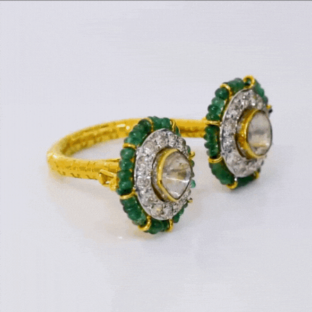 Elevate your style with our captivating fusion ring for two fingers, adorned with a mesmerizing blend of uncut and full-cut diamonds, delicately encircled by vibrant emerald beads.(PGDR0396)