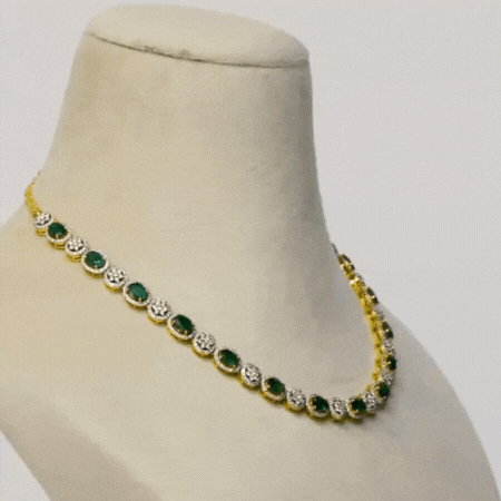 Enchant with elegance in our Emerald oval and diamond necklace and earring pair. Each piece exudes timeless sophistication and luxury.(GDNE0470)