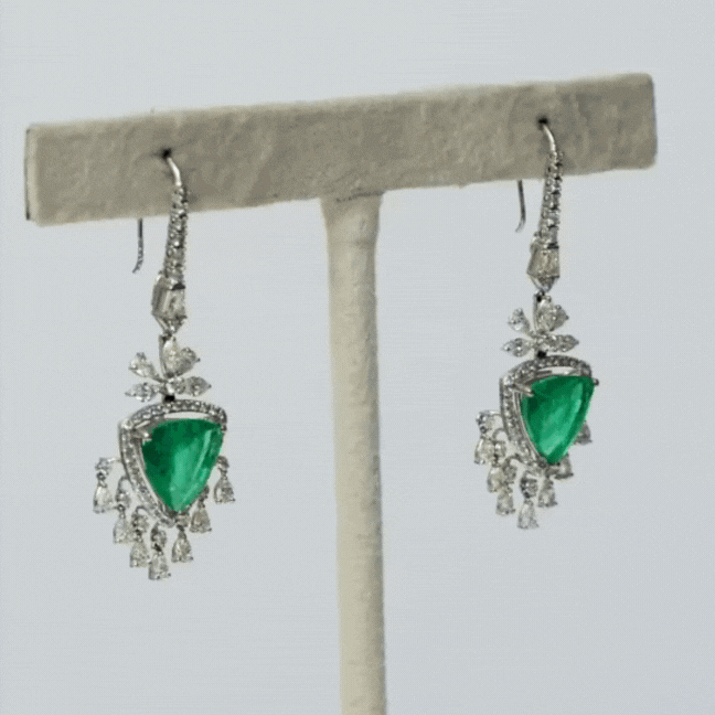 Earring pair with  exquisite triangle-shaped emeralds embraced by fancifully cut diamonds. Elevate your style with this timeless fusion of sophistication and glamour. Shop now and adorn yourself with luxury.(PGDE0288)