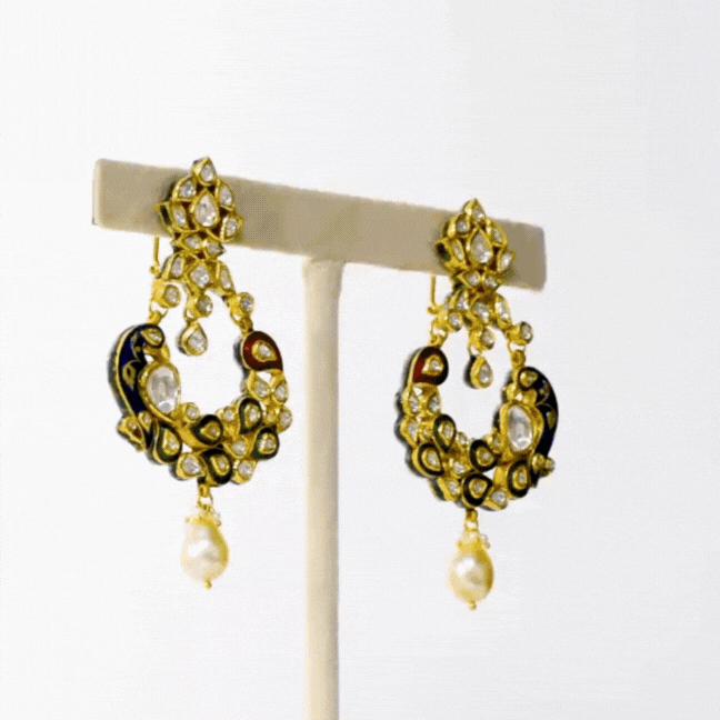 Peacock Meena Chandbali Earring Pair, meticulously crafted to enchant with intricate meenakari work depicting the regal peacock motif. Adorned with glistening uncut diamonds and lustrous pearls.(KMNE3404)