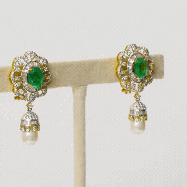 Embrace sophistication and grace with our enchanting earring pair. Featuring mesmerizing emerald-cut ovals adorned with sparkling diamonds, elegantly crowned with South Sea pearl drops accented by diamond caps.(PGDE0381)