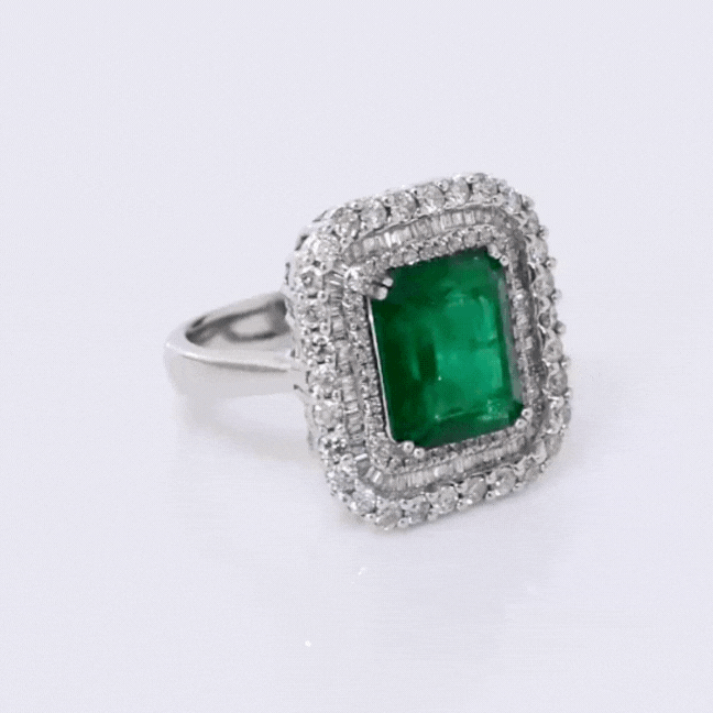 Ring, a dazzling fusion of timeless elegance and natural allure, featuring a captivating Colombian Emerald embraced by sparkling diamonds.(PGDR063)