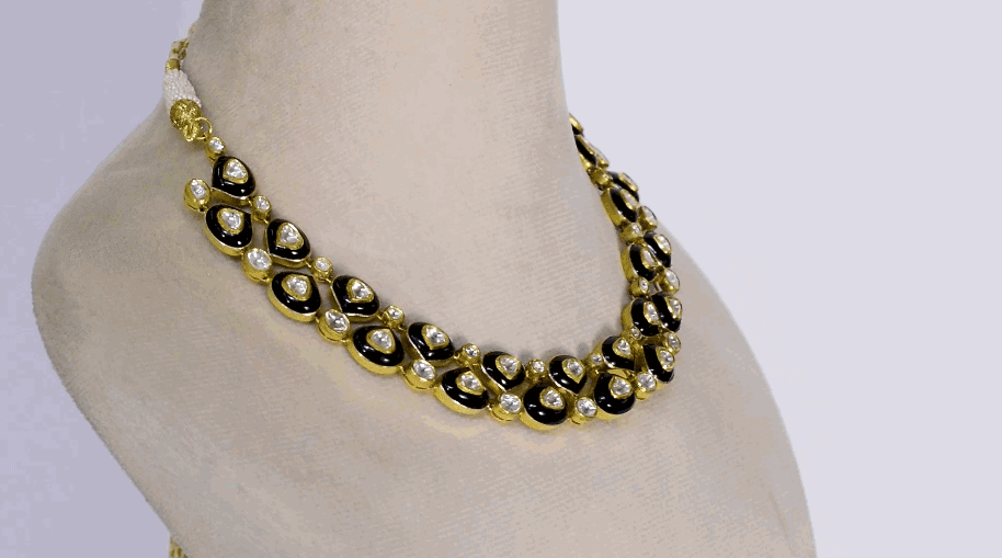 This elegant necklace features sparkling diamond Polki paired with bold black onyx, blending traditional charm with modern style. Handcrafted with precision, it's perfect for festive occasions or evening wear.(WDN1219) + (KME2448)