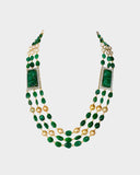 A luxurious necklace with double side pieces showcasing large carved emeralds accented by round diamonds, strung with emerald beads and South Sea pearls for timeless elegance.(WDN1239)