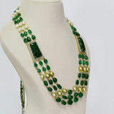 A luxurious necklace with double side pieces showcasing large carved emeralds accented by round diamonds, strung with emerald beads and South Sea pearls for timeless elegance.(WDN1239)