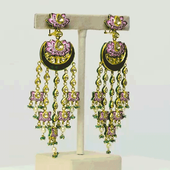 Experience the epitome of elegance with our exquisite long earrings, adorned with delicate pink enameled work, shimmering uncut diamonds, and vibrant green stones. Complete with dangling emerald beads and pearls (KME2182)